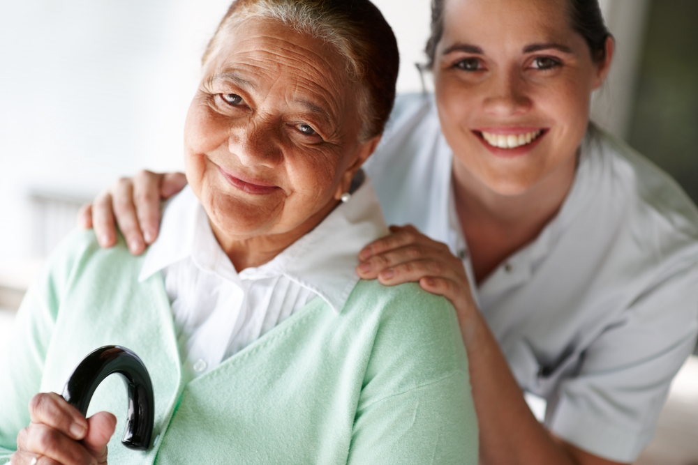 medical staff with elderly female patient smiling